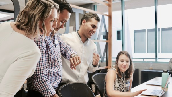 A group of people discussing how to improve internal processes in their small company